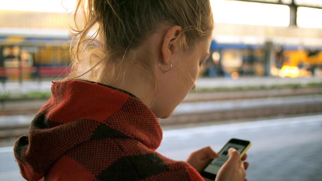 woman using the assessify platform from her mobile phone